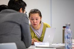 Graduate looking at a laptop